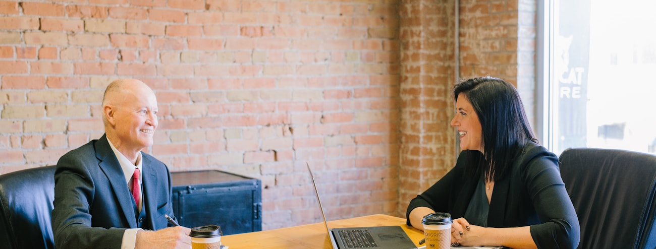 An advocate and a client talking across a conference table
